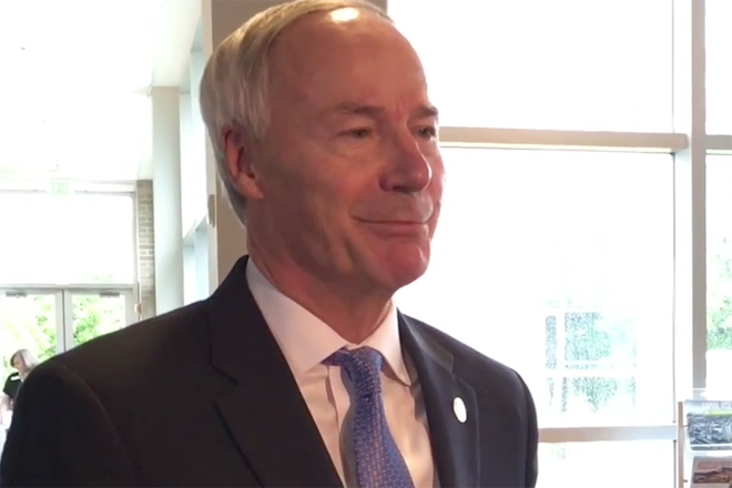 Gov. Asa Hutchinson speaks to reporters at the Little Rock Regional Chamber.