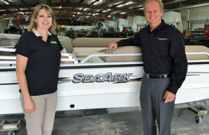 Robin McClendon, who owned SeaArk of Monticello and is a member of its founding family, poses with Correct Craft CEO and President Bill Yeargin after selling SeaArk to the larger private company.
