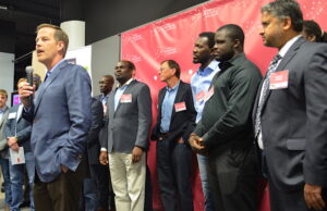 Gary Norcross, chief executive officer of FIS, speaks Monday at the Venture Center in Little Rock. He is surrounded by representatives of the 10 start-ups that were named as participants in the 12-week VC FinTech Accelerator powered by the global technology provider and hosted by the center.