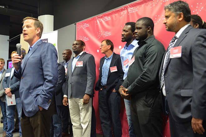 Gary Norcross, chief executive officer of FIS, speaks Monday at the Venture Center in Little Rock. He is surrounded by representatives of the 10 start-ups that were named as participants in the 12-week VC FinTech Accelerator powered by the global technology provider and hosted by the center.