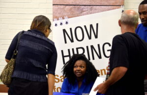 Our House clients talk with potential employers at a job fair at the Career Center's grand opening.&nbsp;