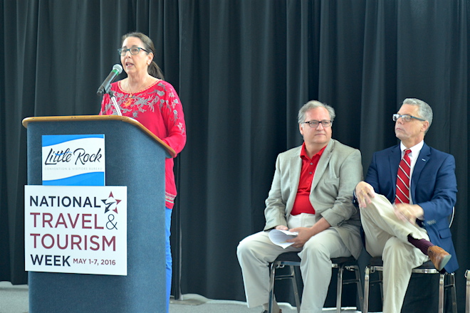 (From left) Capi Peck, chair of the Little Rock Advertising and Promotion Commission, speaks at the "Travel '16'" event Tuesday as John Mayner, vice president of marketing and communications for the Little Rock Convention Center and Kane Webb, executive director of the Arkansas Department of Parks & Tourism, look on.