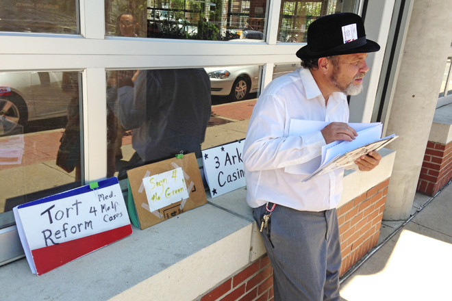 Glen Schwarz gathers petition signatures in Little Rock’s River Market to put proposed amendments  to the Arkansas Constitution on the Nov. 8 ballot.