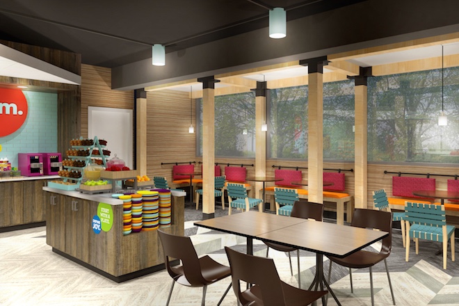 One of the four sections of a Tru by Hilton hotel lobby, featuring multiple seating options and a buffet bar.