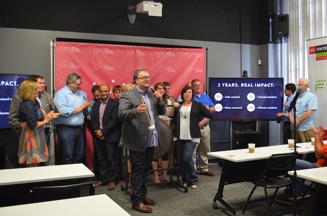Venture Center President Lee Watson on Wednesday, at the first Lift The Rock event, announces that its&nbsp;members have raised $6.8 million in seed capital and created more than 153 jobs in the two years the center has been open.