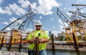 Brad Graves with Kansas City-based Massman Construction Co. checks his Go-Pro camera he is using to take time-lapse photos of the new Broadway Bridge construction project.