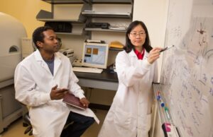SurfTec co-founders Samuel Beckford (left) and Min Zou discuss their research in the Nano Mechanics and Tribology Laboratory at the University of Arkansas in Fayetteville.