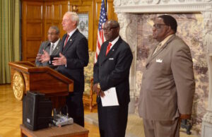 Herman Lessard of the National Urban League, Gov. Asa Hutchsion, Sherman Tate and Ken Wade, both of the Urban League of the State of Arkansas, present the local organization's report.&nbsp;