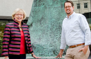 Standing by Henry Moore's sculpture, Large Standing Figure: Knife Edge, valued in the low seven figures, are Millie Ward, a Metrocentre commissioner, and Gabe Holmstrom, executive director of the Downtown Little Rock Partnership.