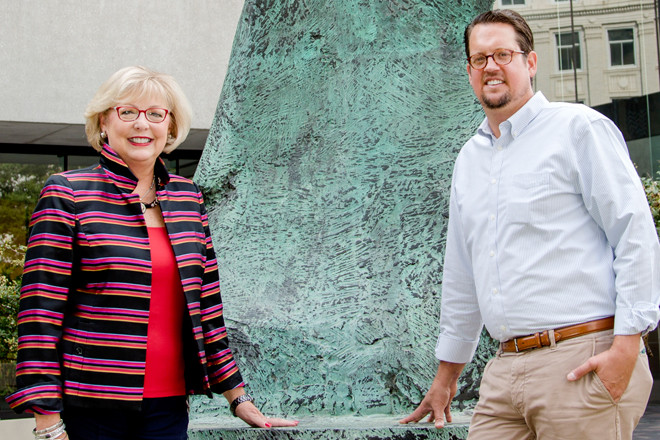 Standing by Henry Moore's sculpture, Large Standing Figure: Knife Edge, valued in the low seven figures, are Millie Ward, a Metrocentre commissioner, and Gabe Holmstrom, executive director of the Downtown Little Rock Partnership.