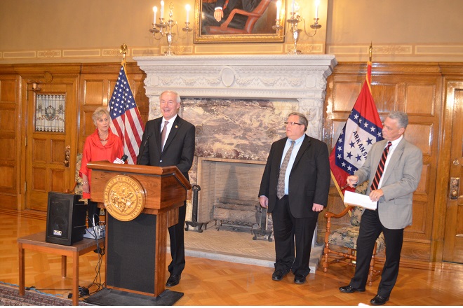 From left, War Memorial Stadium Commissioner Brenda Scisson, Gov. Asa Hutchinson, War Memorial Executive Director Jerry Cohen and Parks & Tourism Director Kane Webb announce that, pending legislative approval, the stadium will be moved under Parks and discretionary funds will be spent on a study that will provide recommendations on the stadium's future needs.&nbsp;