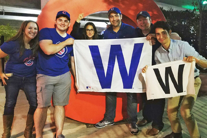 Tom Lillig, center, flies the W. for We Love Cubs