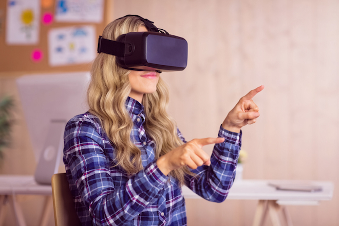 A woman uses an Oculus Rift virtual reality headset.