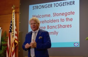 Home BancShares Chairman Johnny Allison announces his company's merger with Stonegate Bank of Florida on Monday at the Little Rock Regional Chamber.