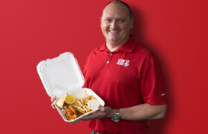 Tom Gordon, CEO and co-founder of Slim Chickens, holds his namesake "Slim's Plate".