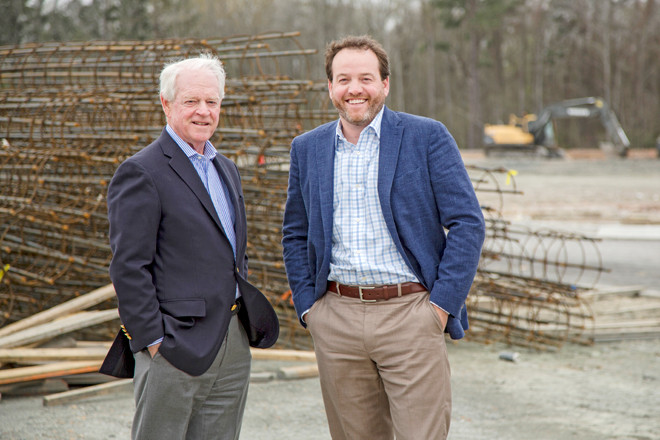 Tommy Hodges (L) and Isaac Smith represent two generations of development at Little Rock’s Gateway Town Center with its growing entertainment draws.