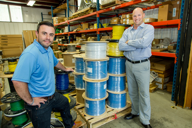 David Roberts, left, senior vice president of Advanced Cabling Systems, and company president Michael Kennedy lead the work-and-fun venture based in North LIttle Rock where double-digit sales growth is a corporate way of life.