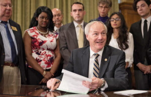 Gov. Asa Hutchinson signs into law the ARFuture Grant Act, which provides up to two years of tuition and fees at community or technical college to students enrolled in certain high-demand fields of study.