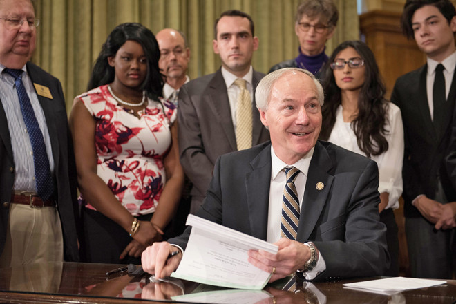 Gov. Asa Hutchinson signs into law the ARFuture Grant Act, which provides up to two years of tuition and fees at community or technical college to students enrolled in certain high-demand fields of study.