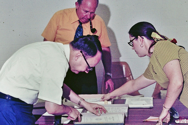 Director of Broadcasting Charles Rasberry, KASU Chief Engineer Roy Barnhill (with pipe) and A-State journalism instructor Rebecca Gardner working on Corporation for Public Broadcasting grant papers in 1975.