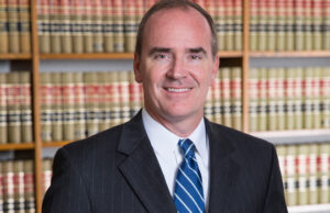 Mark M. Henry, a registered patent attorney, won a $12.4 million verdict against Wal-Mart for a California web design firm.