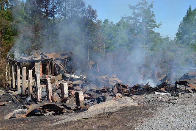 Cotham's Mercantile and restaurant was still smoldering Tuesday, hours after crews responded to an overnight fire at the beloved landmark.