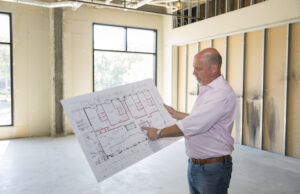 Mitchell Massey looks over plans for a condo in the Legacy Building in Fayetteville.