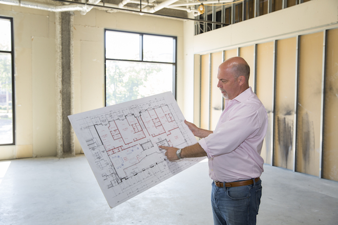 Mitchell Massey looks over plans for a condo in the Legacy Building in Fayetteville.