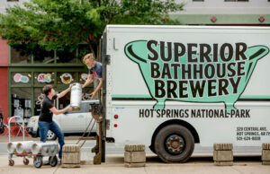 Rose Schweikhart, owner of Superior Bathhouse Brewery in Hot Springs, and Jimm Powell, brewer, head back to the brewery with empty 5-gallon kegs from the delivery truck.