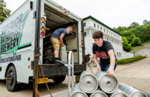 Rose Schweikhart, right, owner of Superior Bathhouse Brewery, and Jimm Powell, brewer, load 5-gallon kegs onto their delivery truck for delivery to bars and restaurants.