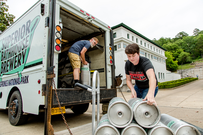 Rose Schweikhart, right, owner of Superior Bathhouse Brewery, and Jimm Powell, brewer, load 5-gallon kegs onto their delivery truck for delivery to bars and restaurants.