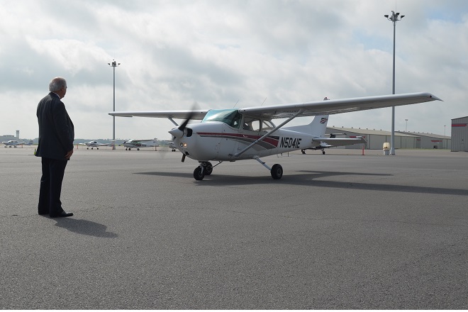 Central Flying Service CEO&nbsp;Dick Holbert watches&nbsp;Chief Flight Instructor Mike Jones and student Kristine Beard finish a historic 475,000 hours of training on Wednesday.&nbsp;