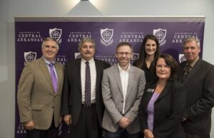 UCA President Houston Davis; Lee Price, Arkansas State Director for the U.S. Department of Labor Office of Apprenticeship and Training; GB Cazes, president of products and services for Metova Inc.; Shelley Mehl, associate vice president of the UCA Division of Outreach and Community Engagement; Mary Dunlap, Arkansas Coding Academy director; and Mark McManus with the Arkansas Department of Workforce Services celebrate the state&rsquo;s first Information Technology Based Registered Apprenticeship Program at UCA.