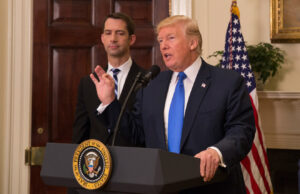 Sen. Tom Cotton, R-Ark., joins President Donald Trump in the Oval Office Aug. 2 to announce a plan to cut the number of visas given to foreign professionals.
