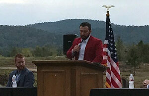 Shaun Keefe, co-owner of WinChoice, listens to CEO Morgan Wiles speaks at Wednesday's announcement in Mountain Pine.