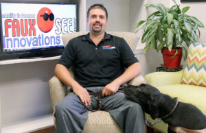 Fauxsee Innovations Founder, President and CEO Brandon Foshee with his guide dog, Shakespeare.