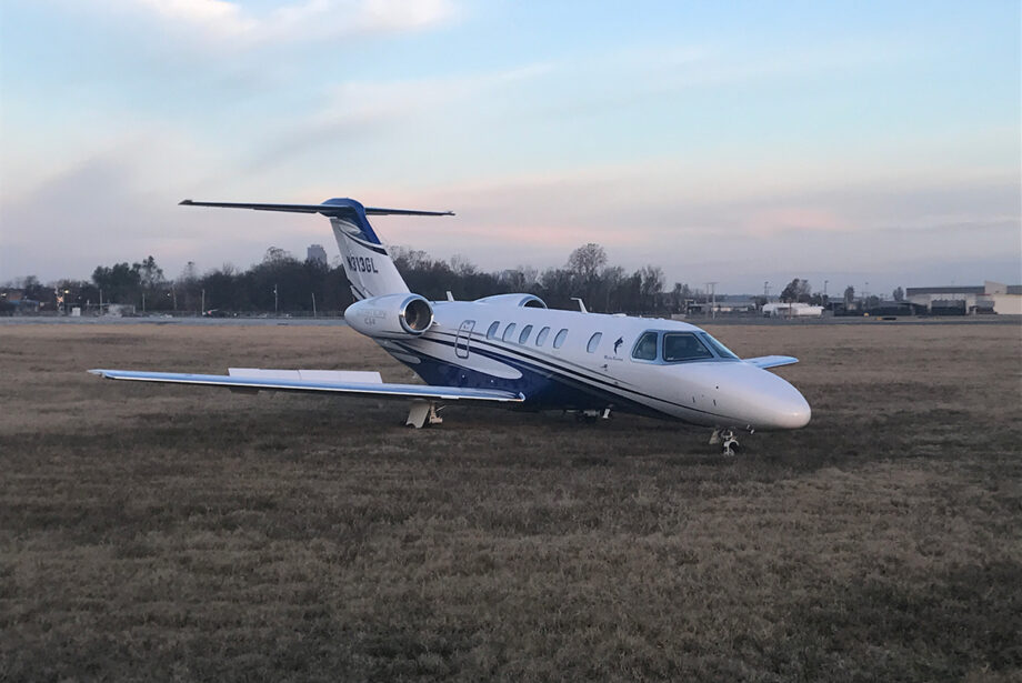 A Cessna Citation CJ4 sits in the grass near a runway on the western side of Clinton National Airport. Greg Hatcher of Little Rock said the aircraft's brakes malfunctioned upon landing.
