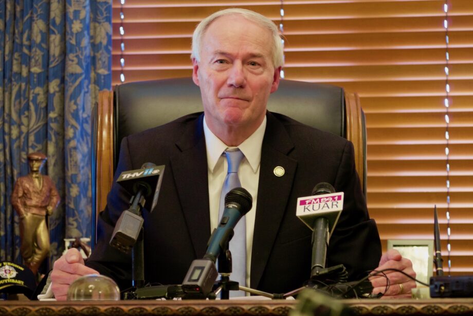 Asa Hutchinson meet with reports to talk about the reduced number of participants in the state's Medicaid program.
