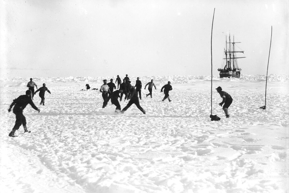 Crewmembers of Ernest Shackleton's Endurance expedition of 1914-1917 play soccer in Antarctica.