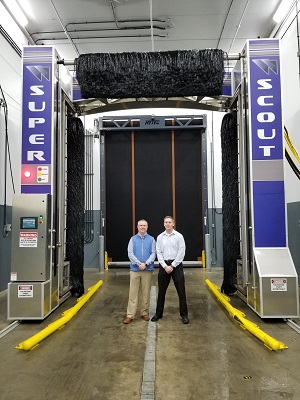 Whiting Systems Inc. President Chad Glenn (left) and former president Russ Whiting, of the family ownership group, with one of the company's large truck wash gantries.