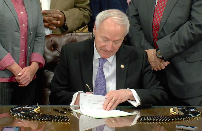 Gov. Asa Hutchinson signs the pharmacy benefit manager law.