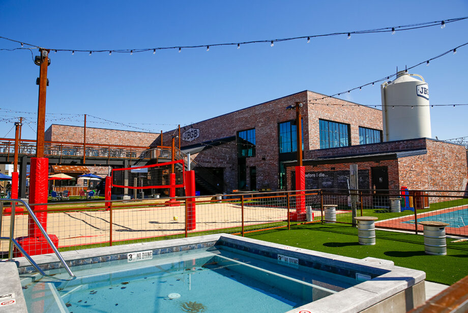 JBGB, which opened in May on Steele Boulevard in Fayetteville, is a 13,000-SF facility featuring corporate offices for Jody Thornton’s JJ’s restaurant operations, a brewery, restaurant and bar and an outdoor stage for musical acts. Volleyball and other outdoor activities are also available.