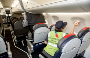 John Frederick, an aviation maintenance technician uses a cleaning sponge to remove dirt and grime from the cabin of an Embraer 175 at the Envoy Air Little Rock Maintenance Base at the Clinton National Airport.