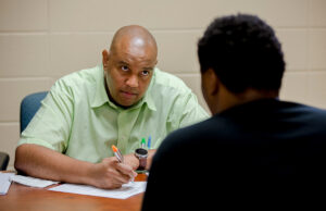 Carlos Clark speaks with an incoming freshman at Arkansas Baptist College in 2018, when he was&nbsp;dean of enrollment management and retention.