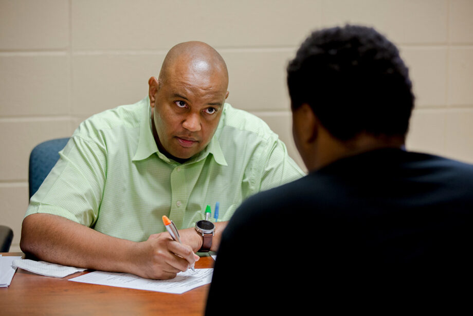 Carlos Clark speaks with an incoming freshman at Arkansas Baptist College in 2018, when he was&nbsp;dean of enrollment management and retention.