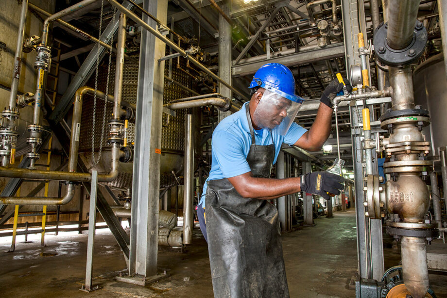 Turrell Williams draws a sample of biodiesel for quality control testing at the Solfuels plant in Phillips County.