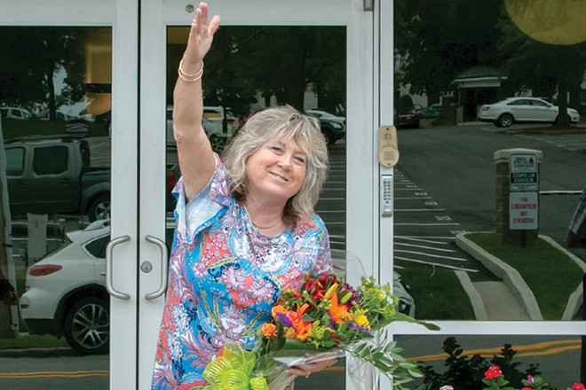 Karen Brown waves goodbye after retiring from her position as executive director of the Arkansas Newspaper Foundation.