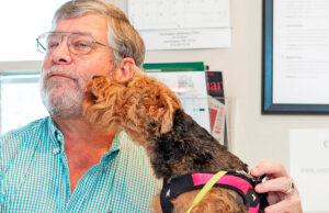 Alan Thompson with a friendly patient at Farmington Veterinary Clinic in northwest Arkansas. Thompson sold his practice to Pathway Vet Alliance of Austin, Texas, which has acquired some 150 veterinarian clinics in the United States.