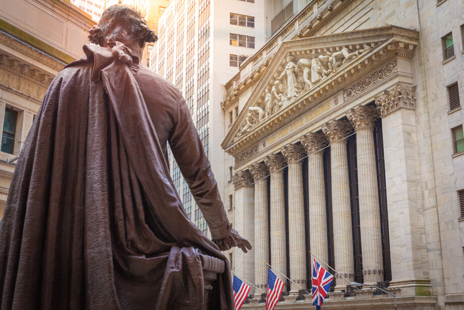 A statue of George Washington looks over the New York Exchange (NYSE) building on Wall Street.