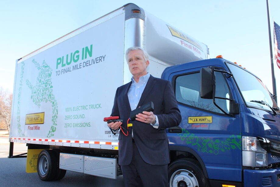 Craig Harper, chief operations officer at J.B. Hunt, shows off one of the&nbsp;five FUSO eCanter all-electric medium-duty box trucks the company has added to its private fleet.